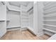 Spacious walk-in closet with custom shelves, rods, and hardwood flooring at 2107 E Maddox Rd, Buford, GA 30519