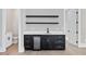 Chic wet bar featuring dark cabinets, quartz countertops, floating shelves, and beverage refrigerator at 2107 E Maddox Rd, Buford, GA 30519