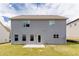 Rear exterior of home featuring a patio, a gray facade, and multiple windows that provide ample light at 2396 Bear Mountain St, Lithonia, GA 30058