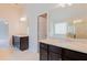 Spacious bathroom featuring double vanity with granite countertops and dark wood cabinets at 2396 Bear Mountain St, Lithonia, GA 30058