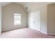 Cozy bedroom featuring a window and closet with paneled doors and neutral-colored walls at 2396 Bear Mountain St, Lithonia, GA 30058