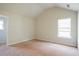 Bedroom with vaulted ceiling, neutral carpet, and natural light from window at 2396 Bear Mountain St, Lithonia, GA 30058