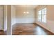 Elegant dining room with hardwood floors, wainscoting, and a large window for ample natural light at 2396 Bear Mountain St, Lithonia, GA 30058