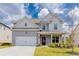 Charming two-story home with a gray exterior, manicured lawn, and attached two-car garage at 2396 Bear Mountain St, Lithonia, GA 30058