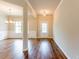 Inviting foyer featuring gleaming hardwood floors, elegant lighting, and classic molding details at 2396 Bear Mountain St, Lithonia, GA 30058