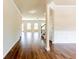 Open hallway with hardwood floors, leading to the staircase and living areas at 2396 Bear Mountain St, Lithonia, GA 30058