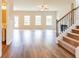 Open-concept living room with hardwood floors, a fireplace, and plenty of natural light at 2396 Bear Mountain St, Lithonia, GA 30058