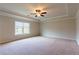 Large main bedroom with trey ceiling, ceiling fan, window, and neutral carpet at 2396 Bear Mountain St, Lithonia, GA 30058