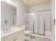 All-white bathroom with glass enclosed shower, large sink, and updated mirror at 295 Langshire Dr, Mcdonough, GA 30253