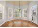 Breakfast nook with large windows, hardwood floors, chandelier, and door to the outside at 295 Langshire Dr, Mcdonough, GA 30253