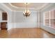 Elegant dining room featuring a stylish chandelier and beautiful hardwood floors at 295 Langshire Dr, Mcdonough, GA 30253