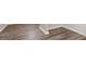 Close-up of luxury vinyl plank (LVP) flooring with white baseboards at 295 Langshire Dr, Mcdonough, GA 30253