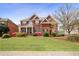Beautiful two-story brick home with well-manicured lawn and colorful landscaping at 295 Langshire Dr, Mcdonough, GA 30253
