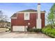 Spacious two-car garage and lengthy driveway on a well-maintained brick home at 295 Langshire Dr, Mcdonough, GA 30253