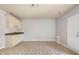 Open kitchen featuring tile flooring, white cabinets, and stainless appliances at 295 Langshire Dr, Mcdonough, GA 30253
