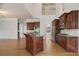 Open kitchen with wood cabinets, stainless steel appliances, large island, and hardwood floors at 295 Langshire Dr, Mcdonough, GA 30253