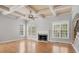 Bright living room with a coffered ceiling, fireplace, and hardwood floors at 295 Langshire Dr, Mcdonough, GA 30253