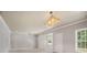 Living room with staircase, carpet, and modern lighting fixture at 295 Langshire Dr, Mcdonough, GA 30253