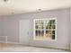 Room featuring tile flooring, gray walls, and a window with a view at 295 Langshire Dr, Mcdonough, GA 30253