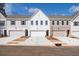 View of new townhomes featuring individual garages and well-maintained landscaping at 409 Carrera Ln, Acworth, GA 30102