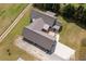 Stunning aerial view of the rear of the home with a metal roof, concrete driveway, and luscious green lawn at 111 Ayers Driver Rd, Villa Rica, GA 30180