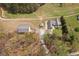 Lovely aerial view of a home, barn and shed, all with matching metal roofs surrounded by lush landscaping and mature trees at 111 Ayers Driver Rd, Villa Rica, GA 30180
