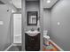 Bathroom features shower with glass door, toilet, vanity sink, and wood look flooring at 111 Ayers Driver Rd, Villa Rica, GA 30180