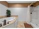 Clean bathroom featuring a soaking tub and separate shower with white wainscoting at 111 Ayers Driver Rd, Villa Rica, GA 30180