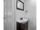 Bathroom featuring white walls, dark vanity, mirror and sink at 111 Ayers Driver Rd, Villa Rica, GA 30180