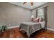 Cozy bedroom with ceiling fan, wood flooring, and soft natural light at 111 Ayers Driver Rd, Villa Rica, GA 30180