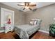 Comfortable bedroom with a ceiling fan, warm wood floors, and decorative accents at 111 Ayers Driver Rd, Villa Rica, GA 30180