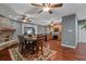 Open dining room featuring a stone fireplace, wood floors, and view into the kitchen at 111 Ayers Driver Rd, Villa Rica, GA 30180