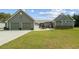 Welcoming home exterior with a lush green lawn and attached two-car garage at 111 Ayers Driver Rd, Villa Rica, GA 30180