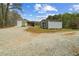 A view of multiple outbuildings on the property and gravel driveway at 111 Ayers Driver Rd, Villa Rica, GA 30180