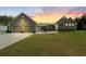 Charming exterior showcasing a two-car garage and manicured lawn at sunset at 111 Ayers Driver Rd, Villa Rica, GA 30180