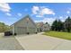 Well-maintained garage with gray siding, two doors, and spacious driveway at 111 Ayers Driver Rd, Villa Rica, GA 30180
