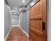 Hallway features beautiful wood flooring, neutral colored walls, and sliding barn door at 111 Ayers Driver Rd, Villa Rica, GA 30180