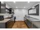 Galley kitchen featuring dark cabinets, stainless steel countertops, and modern appliances at 111 Ayers Driver Rd, Villa Rica, GA 30180