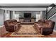Inviting living room with plush seating, a stone fireplace, and wood flooring at 111 Ayers Driver Rd, Villa Rica, GA 30180