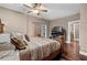 Comfortable main bedroom with a decorative bed frame, wood floors, and fireplace at 111 Ayers Driver Rd, Villa Rica, GA 30180