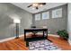 Well-lit office space featuring a modern desk, wood floors, and plenty of natural light from three windows at 111 Ayers Driver Rd, Villa Rica, GA 30180