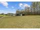Expansive property view showcasing the land, outbuildings, and surrounding greenery at 111 Ayers Driver Rd, Villa Rica, GA 30180