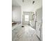 Bright, white bathroom with marble tile flooring, double vanity, soaking tub and natural light at 1166 Farmstead Rd, Suwanee, GA 30024