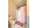 Cozy bathroom featuring a shower with a peach-colored shower curtain and a white tile floor at 1166 Farmstead Rd, Suwanee, GA 30024