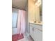 Clean bathroom featuring a shower-tub combo, white vanity, and marble floors at 1166 Farmstead Rd, Suwanee, GA 30024