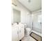 Bathroom featuring a walk in shower, white vanity and lots of natural lighting at 1166 Farmstead Rd, Suwanee, GA 30024