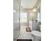 Bright bathroom featuring a glass enclosed walk in shower and white vanity at 1166 Farmstead Rd, Suwanee, GA 30024