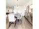 Dining space with decorative lighting fixture, hardwood floors, and views to the living room at 1166 Farmstead Rd, Suwanee, GA 30024