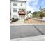 A bright, white two-story townhome with a quaint balcony and attached one car garage at 1166 Farmstead Rd, Suwanee, GA 30024