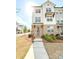 Charming three-story townhouse with brick accents and well-maintained landscaping at 1166 Farmstead Rd, Suwanee, GA 30024